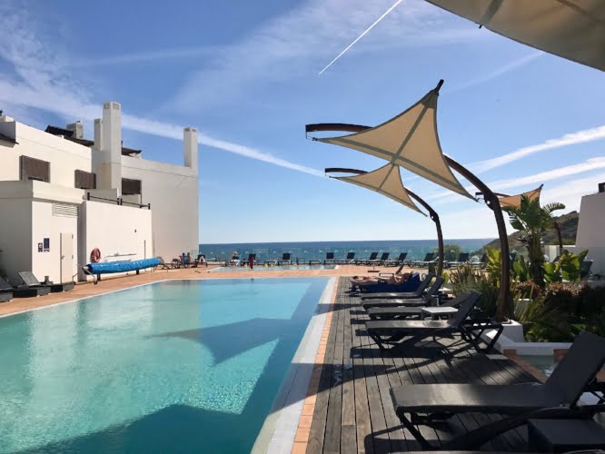 Pool and shade covers overlooking the beach at Porto de Mós.
