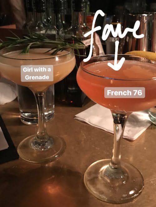 Yellow drink in a coupe glass, next to a red drink in a coupe glass. 
