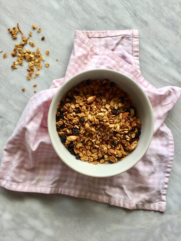 Vanilla, almond and coconut granola on a pink towel, on a marble background. 