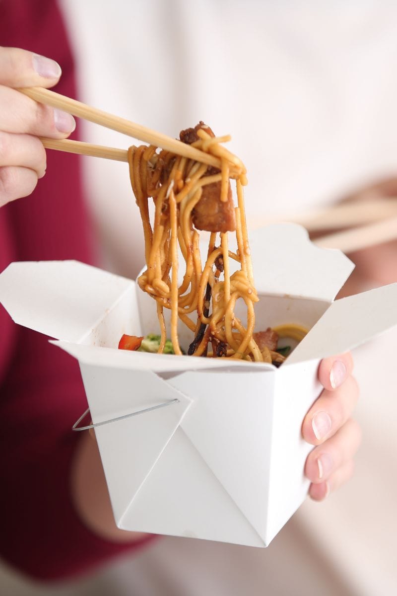 White takeaway container with noodles to showcase PFAS in takeaway food containers.